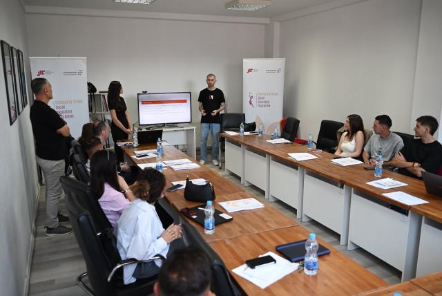 Person pitching ideas in front of panel