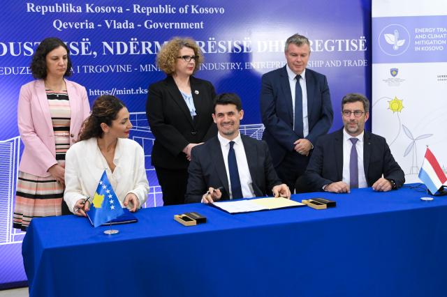 Officials smiling after signature