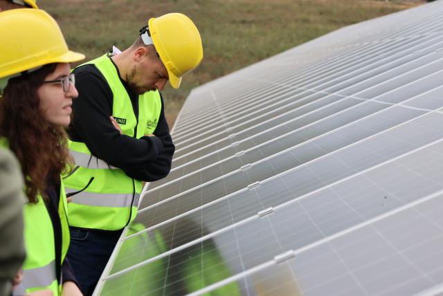 Technicians watching over solar panels