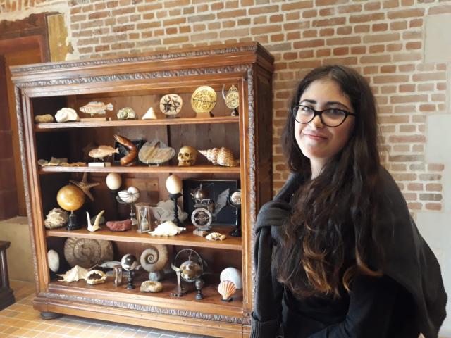 Liza posing for a photo at a museum