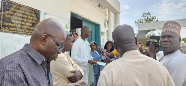 Personnes rassemblées devant l'entrée d'un bâtiment