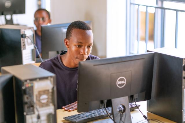 Student behind a screen in an IT room