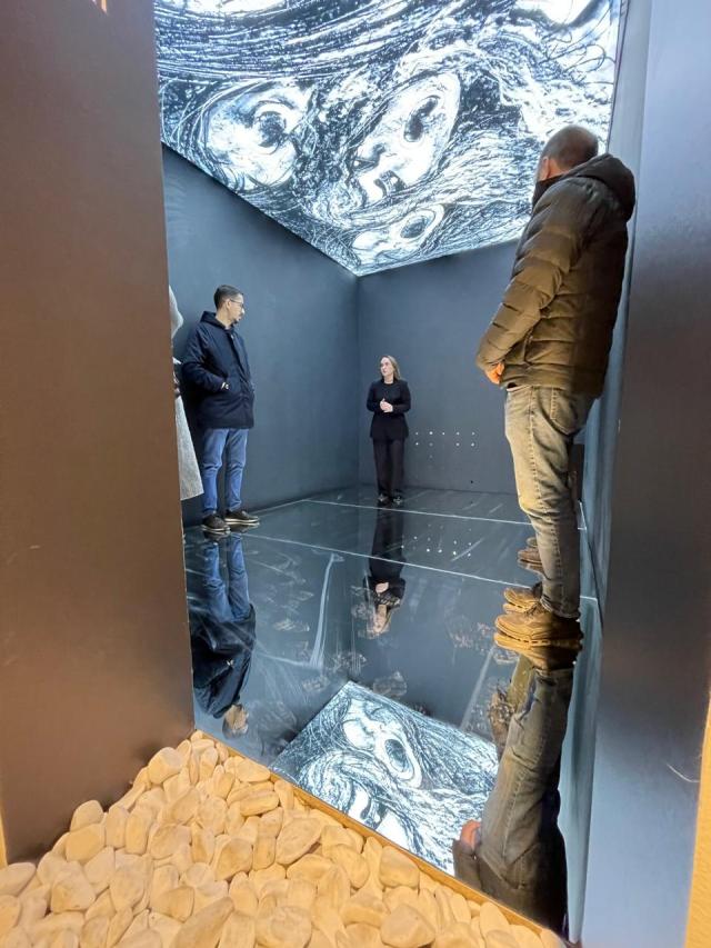 Visitors at museum listening to guide
