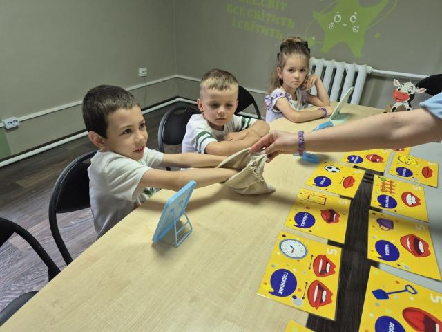 Three children taking part in a speech and language therapy session