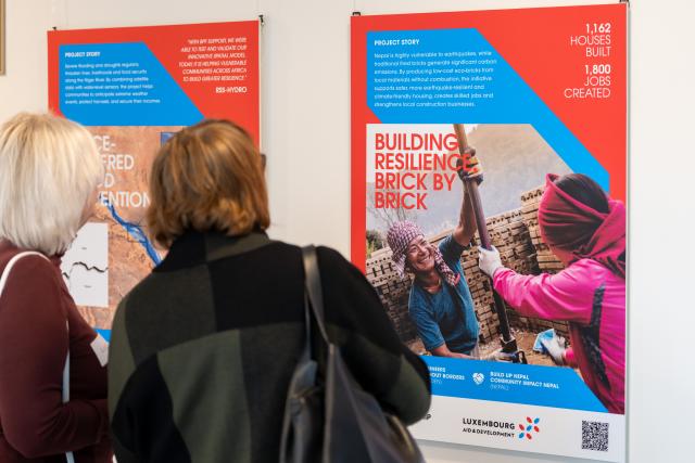People looking at exhibition panels