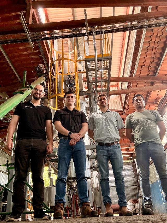 A group of 4 men in a factory